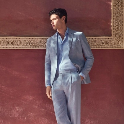 Model wearing a light blue Etro Summer suit in breezy linen with a tonal shirt.