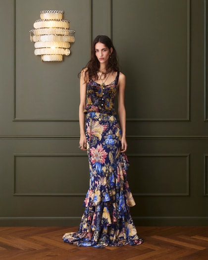 Model wearing an Etro floral-print sleeveless maxi dress with layered ruffle hem in blue and multicolor tones.