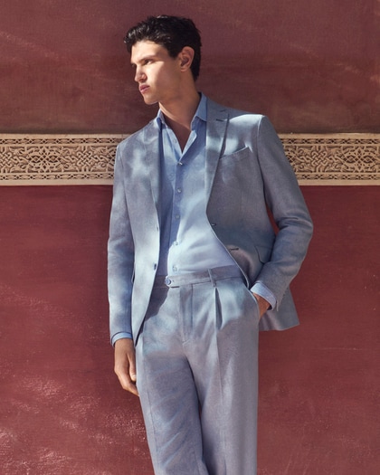 Model wearing a light blue Etro Summer suit in breezy linen with a tonal shirt.
