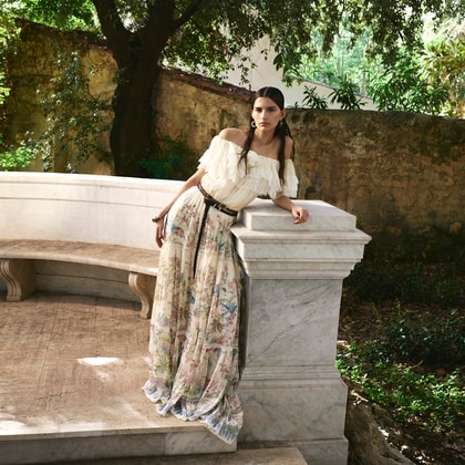 Model wearing Etro long silk dress with placed flora and fauna print