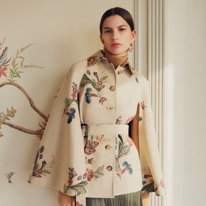 Model wearing Etro cape-style trench coat with floral print