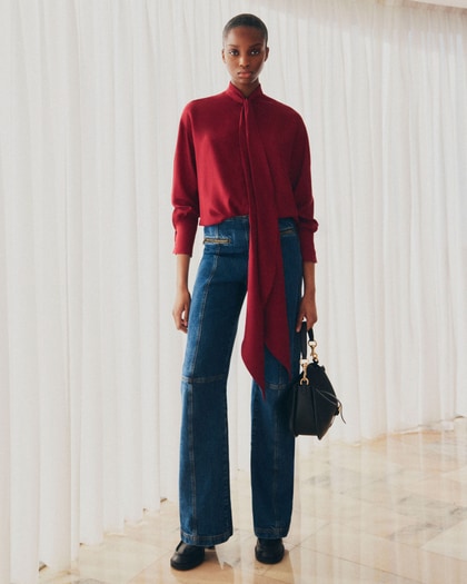 Model wearing a silk jacquard blouse Etro with pink background