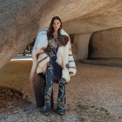 Woman in a fur coat and embroidered jeans from Etro Fall/Winter 2025 collection.