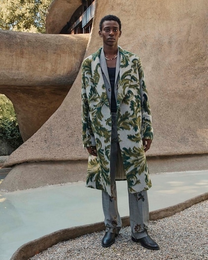 Man in a long green-patterned coat and gray trousers from Etro Fall/Winter 2025 collection.