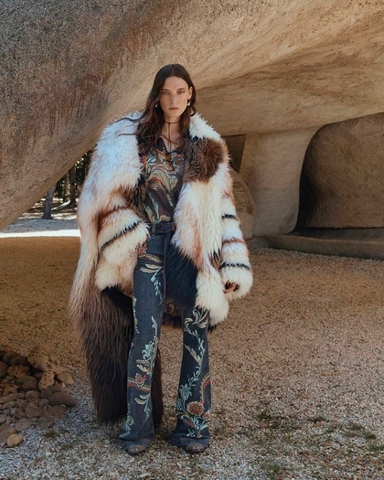 Woman in a fur coat and embroidered jeans from Etro Fall/Winter 2025 collection.