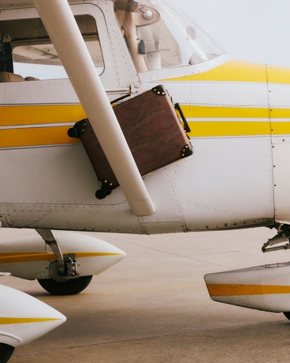 A plane holding a Etro x Globe-trotter luggage in Arnica