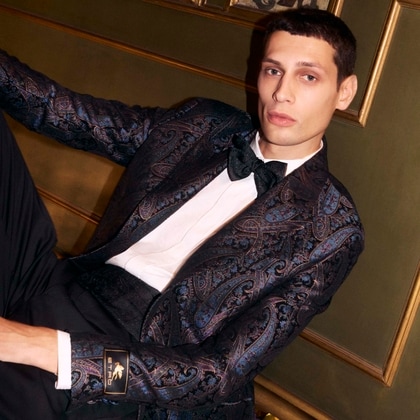 Model seated in a Etro suit of Etro Holiday Collection