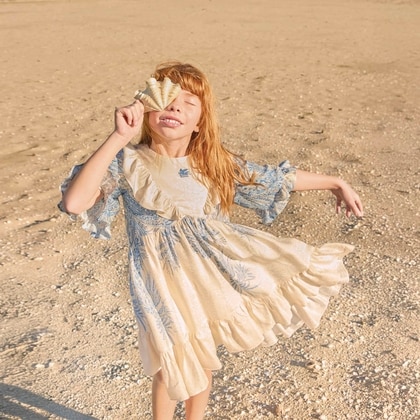 Little girl on a beach wearing Etro dress