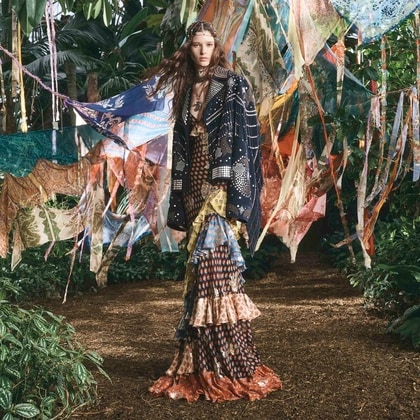 Model in a lush jungle setting wearing a Etro dress of ss26 runway collection