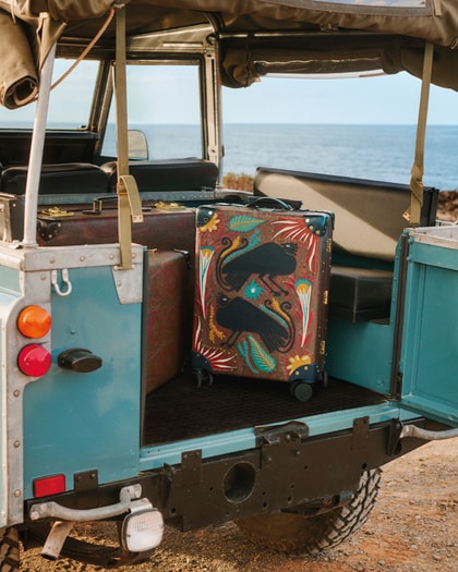 Etro x Globe-Trotter Trolley on a jeep with sea background