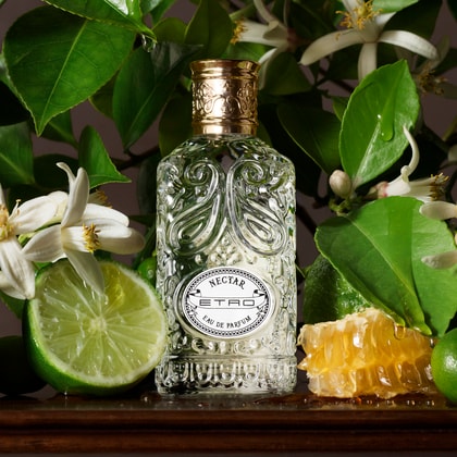 NECTAR Etro Fragrance bottle with a background representing the ingredients of the parfum