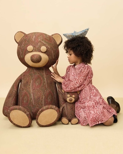 Kid wearing Etro dress near a teddy bear in Etro Arnica material