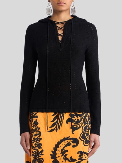 KNIT TOP WITH CROSSOVER AND PUNCHED DETAIL